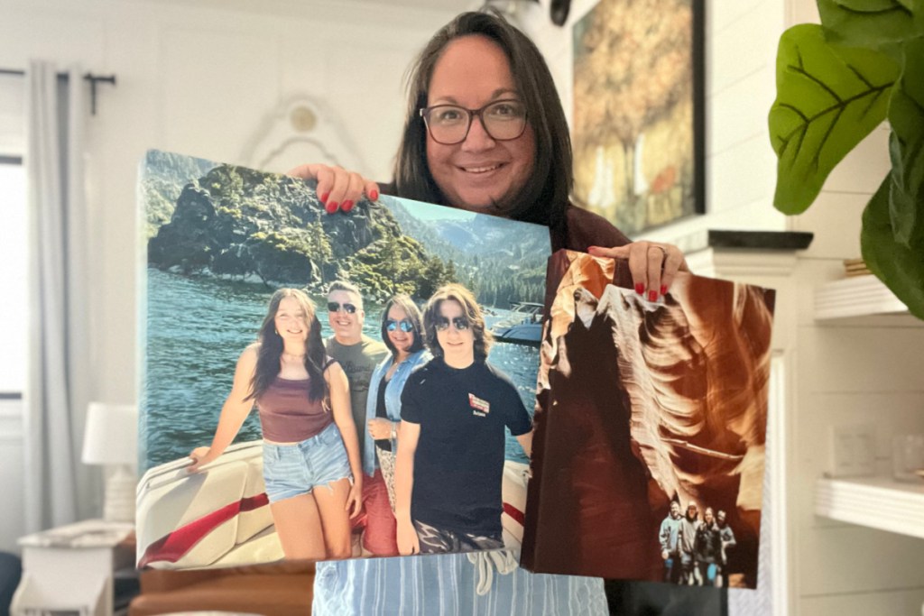 woman holding two canvases