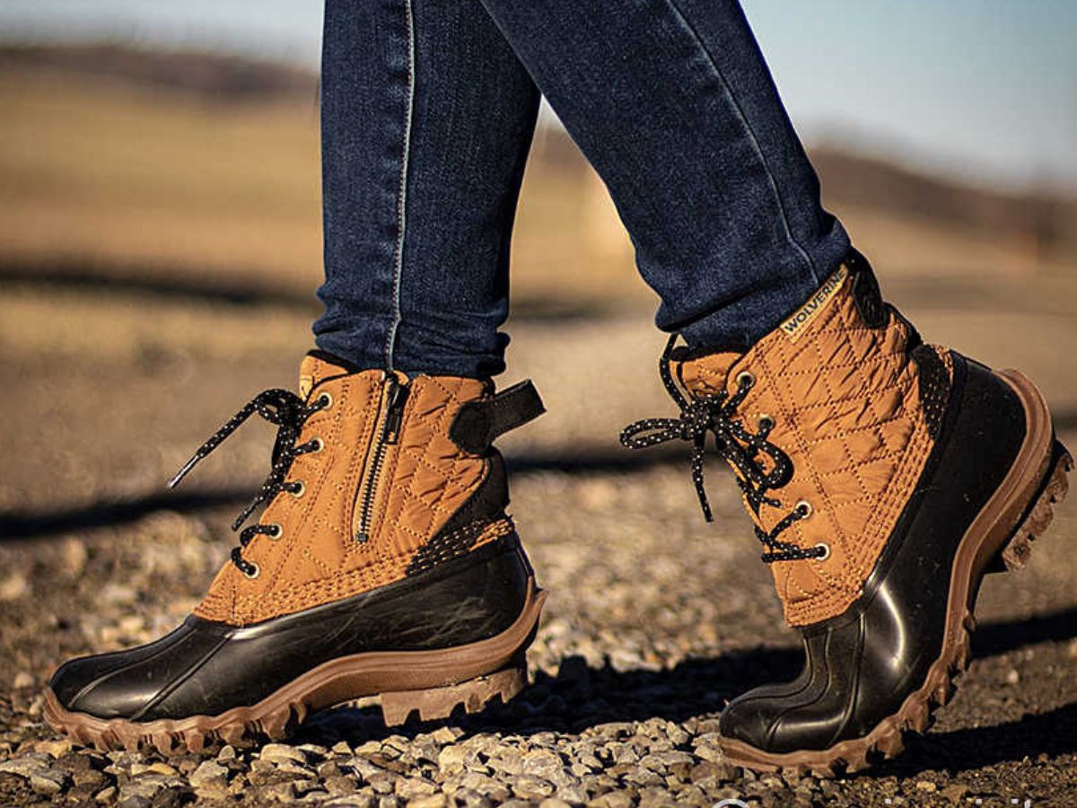 person walking on rocks wearing Wolverine boots