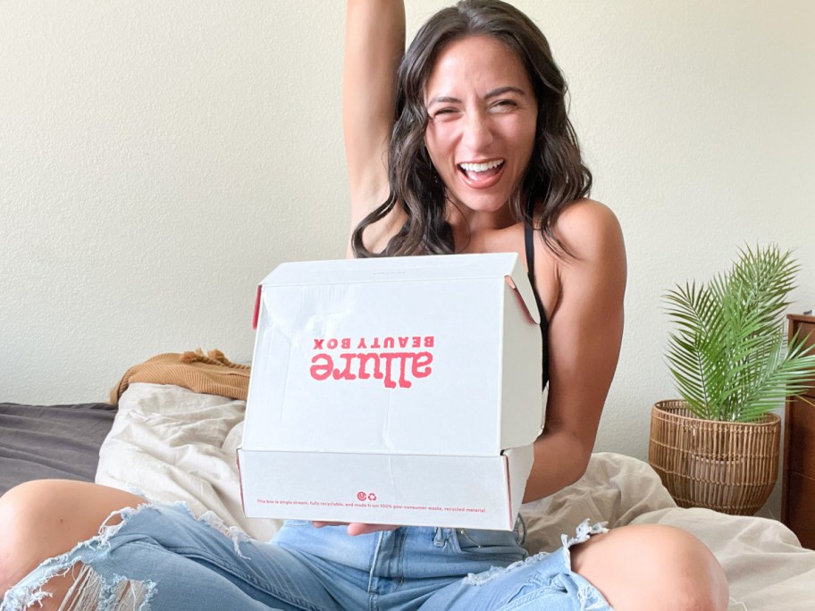 woman holding allure box holding it open with a smile on her face