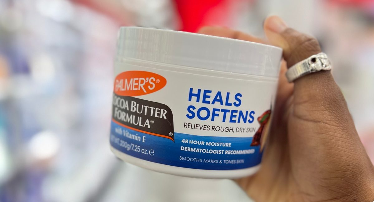 woman holding palmers coca butter formula heals softens at the store