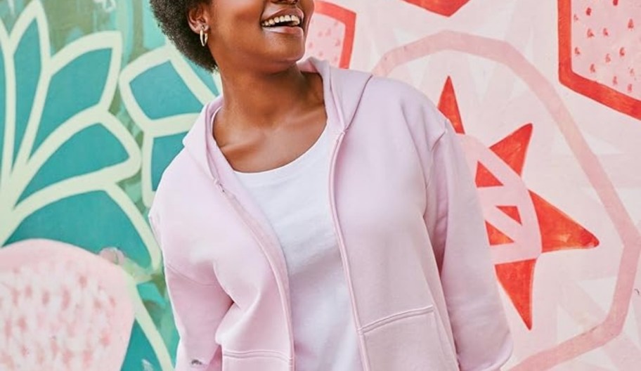 a wpman smiling in a pink fleece hoodie