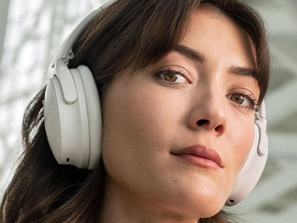 woman wearing Bose headsets while being outside