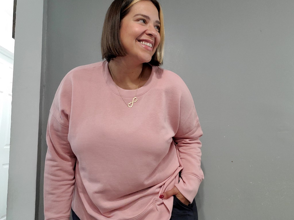 woman wearing pink pullover top from Walmart 