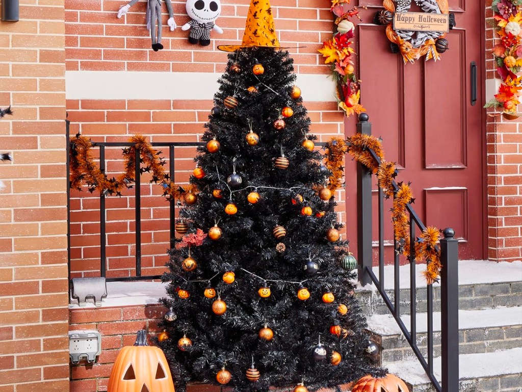 black halloween christmas tree decorated with pumpkins