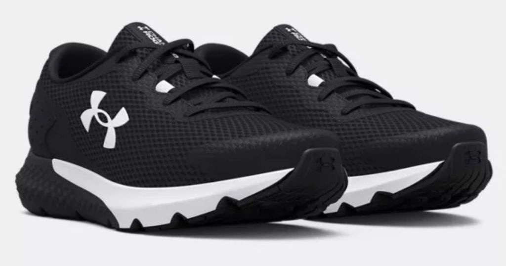 pair of Under Armour boys shoes in black and white