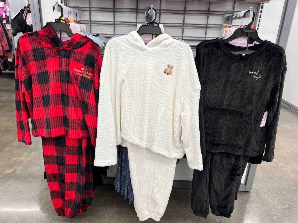walmart rack with 3 pairs of women's holiday pajamas displayed