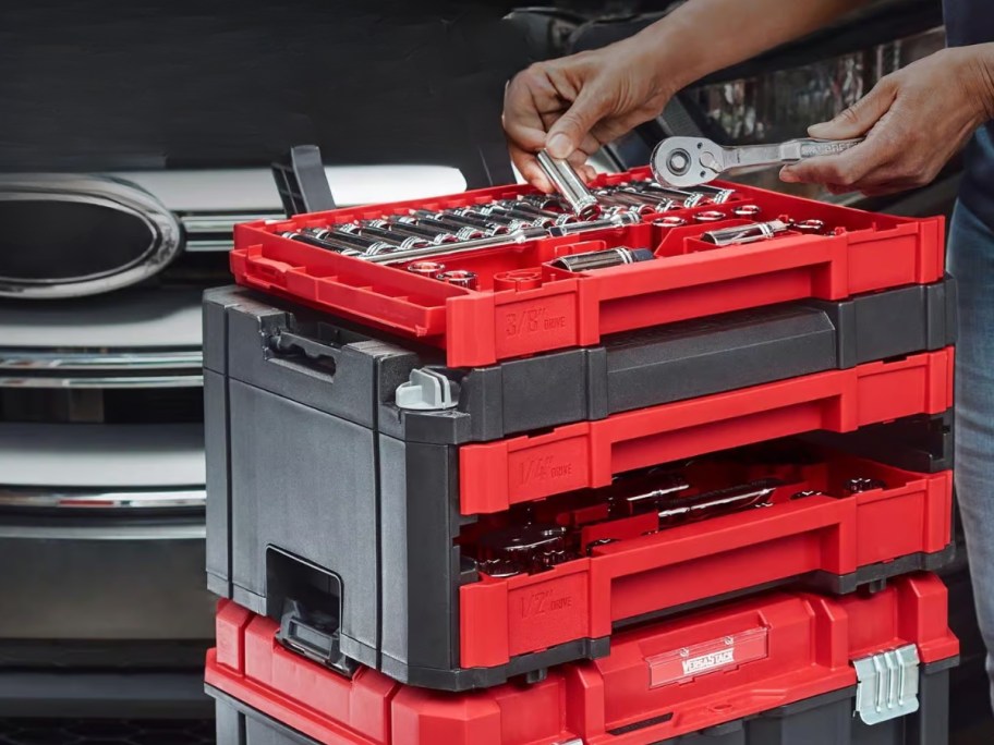 person's hands putting tools into a red and black stacking tool box - Craftsman Versastack SAE Mechanic's Tool Set 230-Piece 