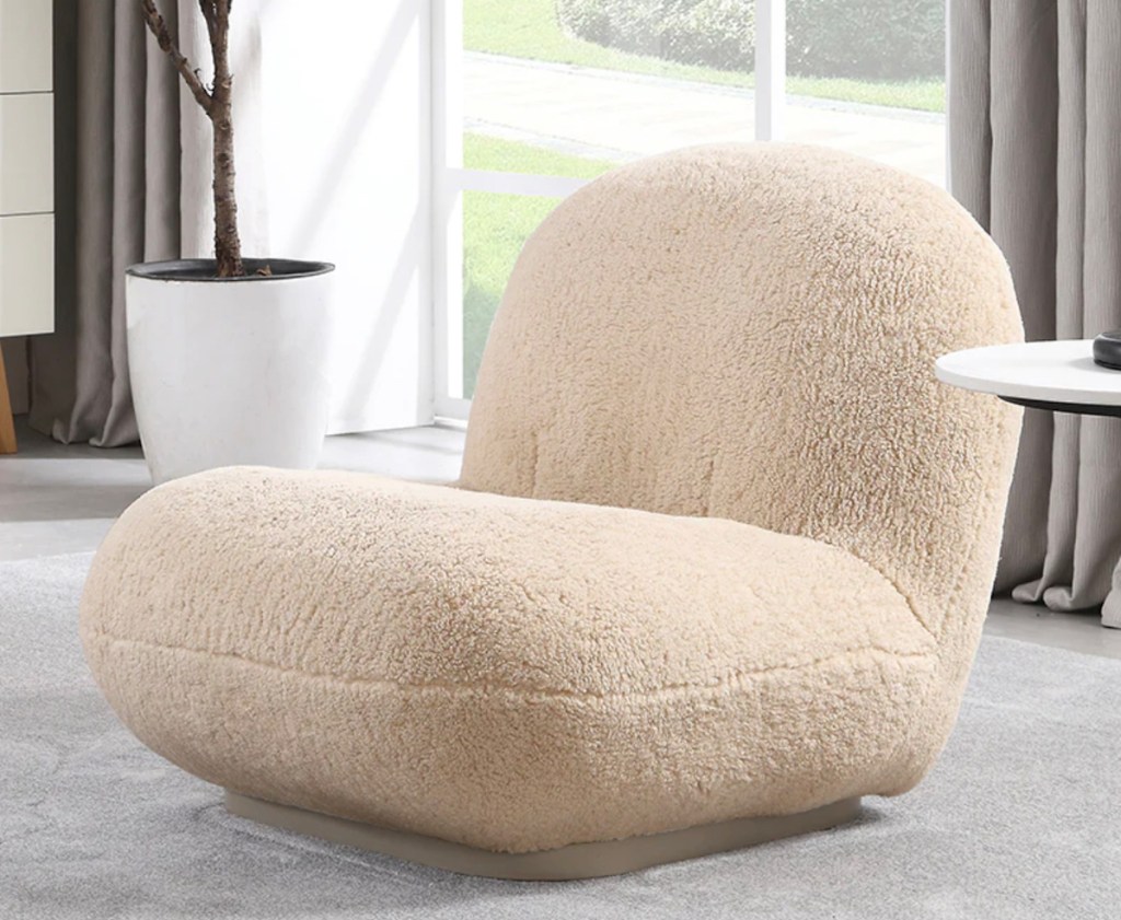 Cream sherpa accent chair on gray carpet floor