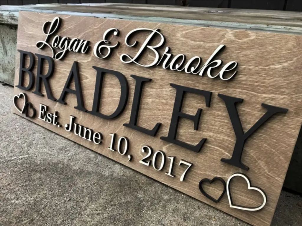 custom made wooden sign with couple's name and wedding date and hearts