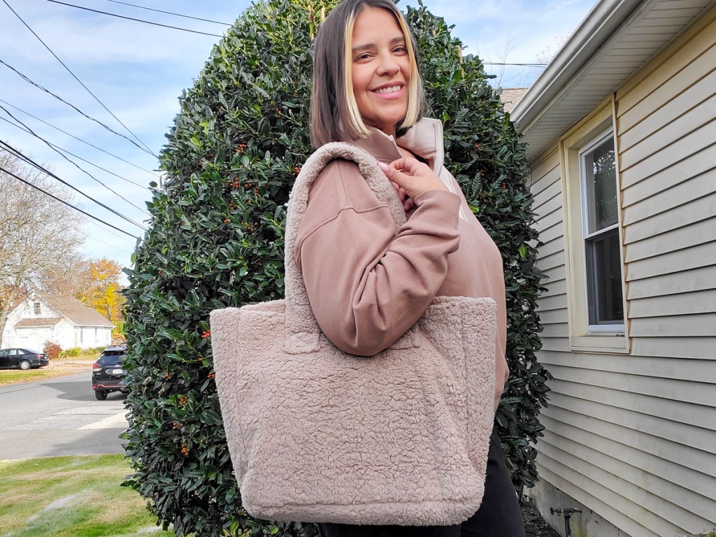 woman with a brown sherpa tote bag
