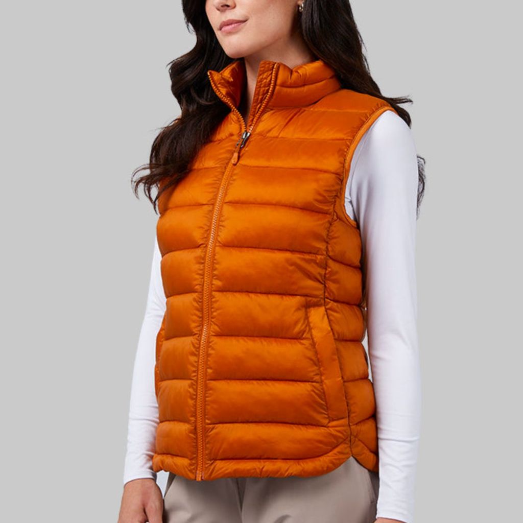 a female model wearing a 32 Degrees Women's Lightweight Poly-Fill Packable Vest