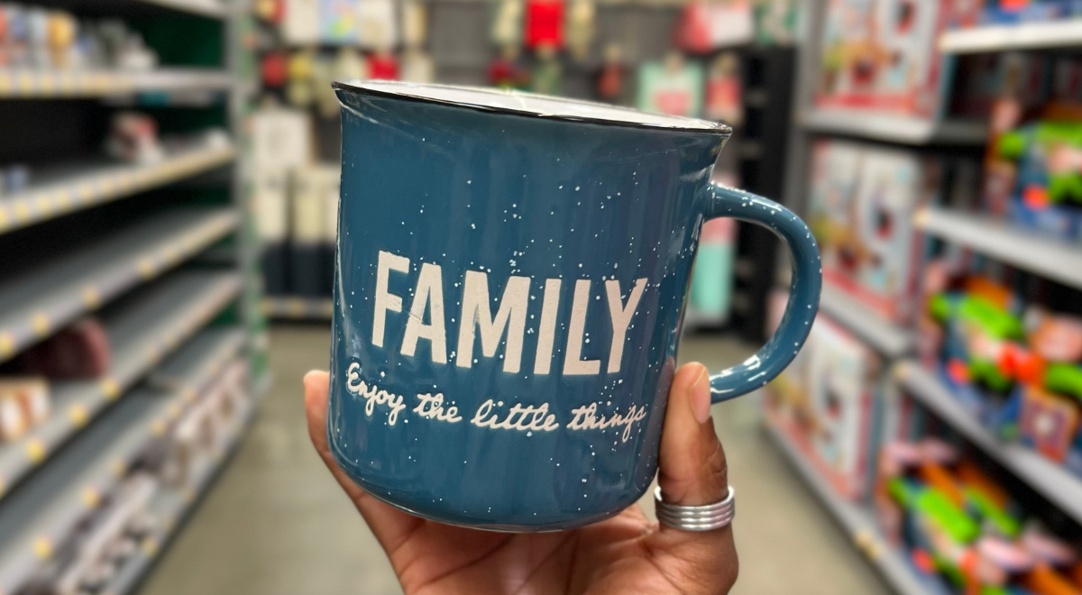 hand holding blue Family themed candle mug