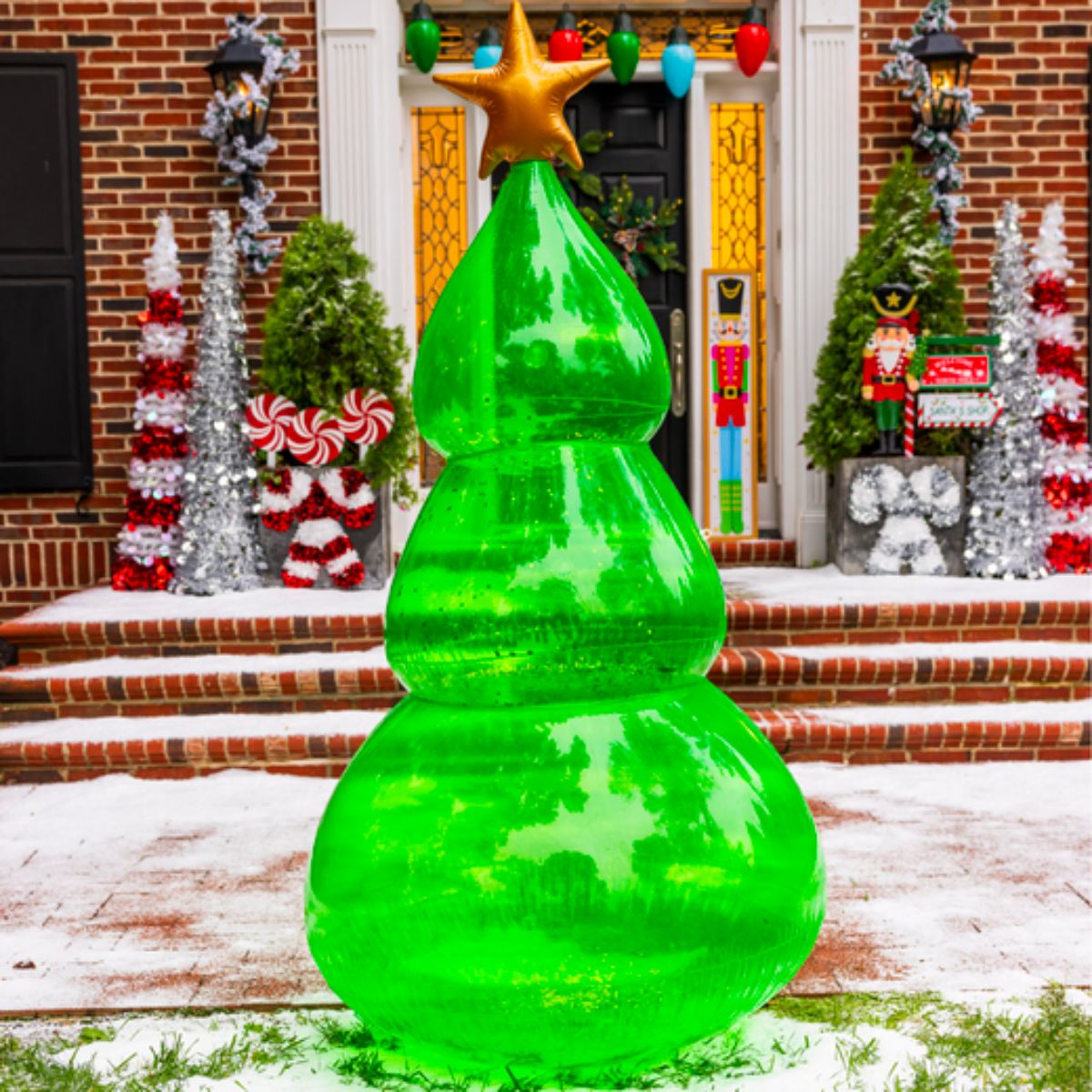 6ft inflatable christmas tree blown up on a snowy decorated lawn