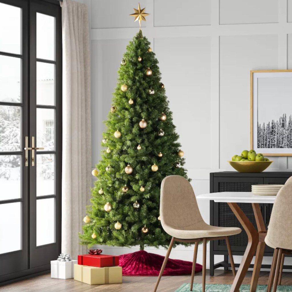 tall christmas tree with gifts in dining room
