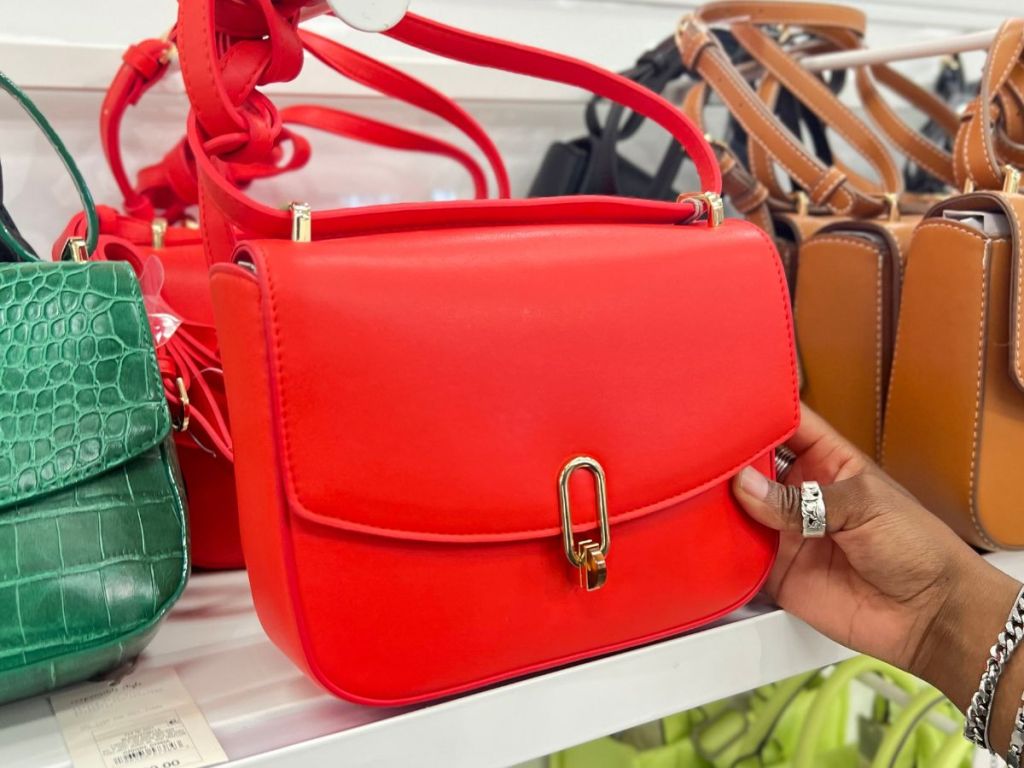 a womans hand displaying A New Day Refined Crossbody Bag red