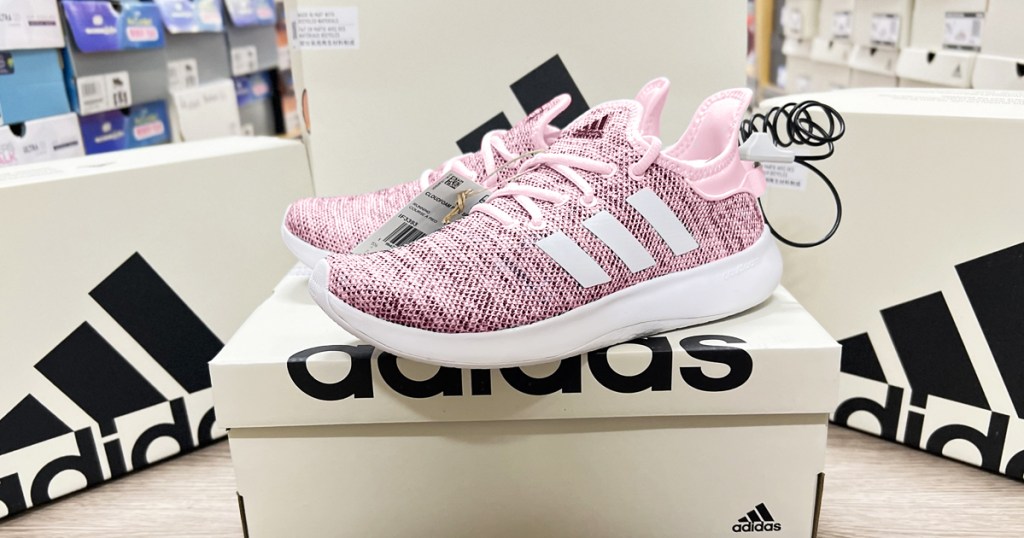 pair of pink adidas sneakers on top of shoe box