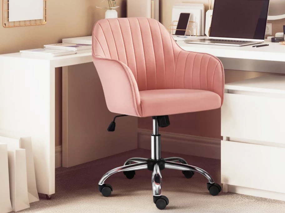 pink rolling chair near white corner desk