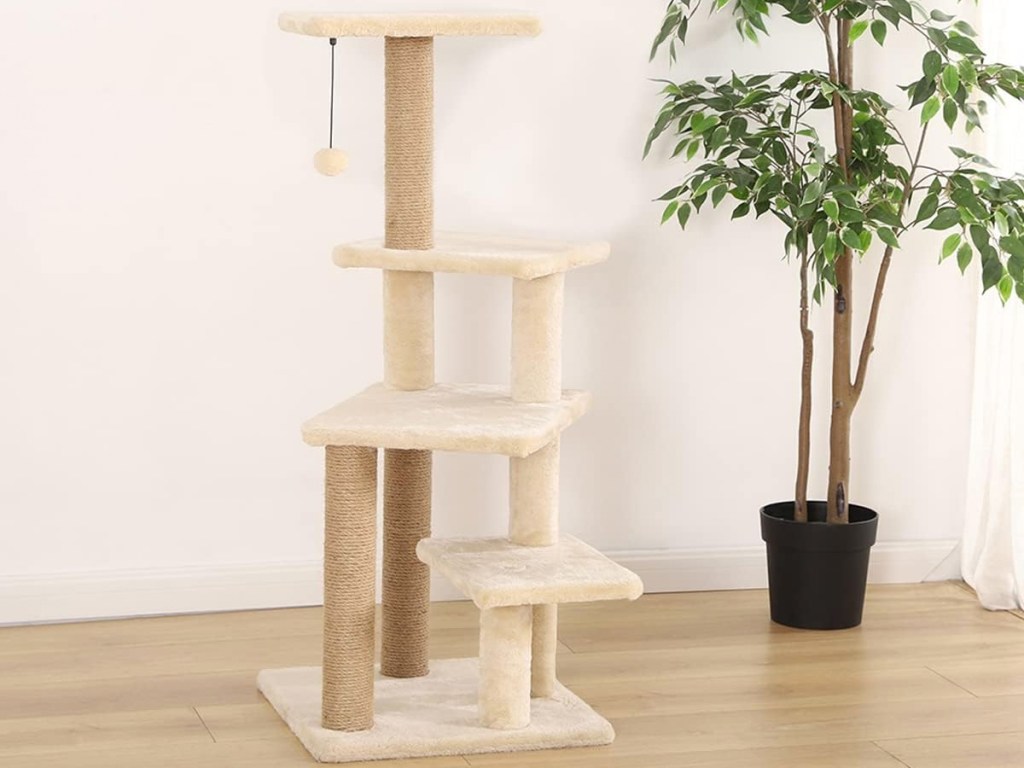 multi-level cat tower near a potted plant