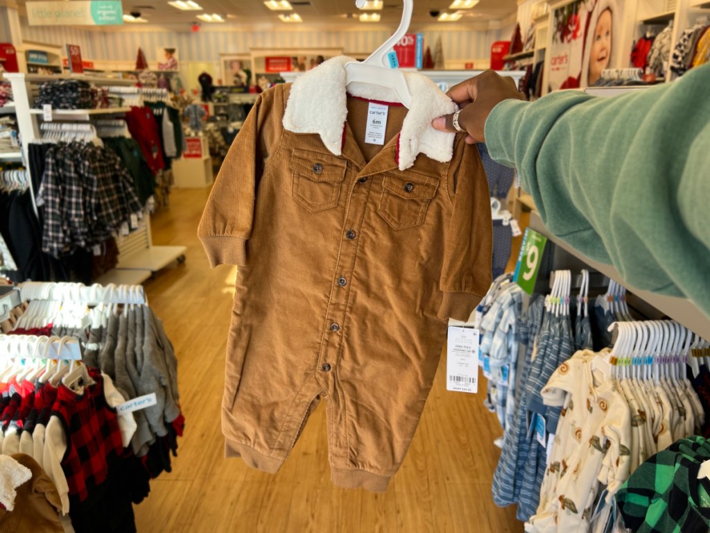 person holding up Baby Corduroy Jumpsuit inside carters