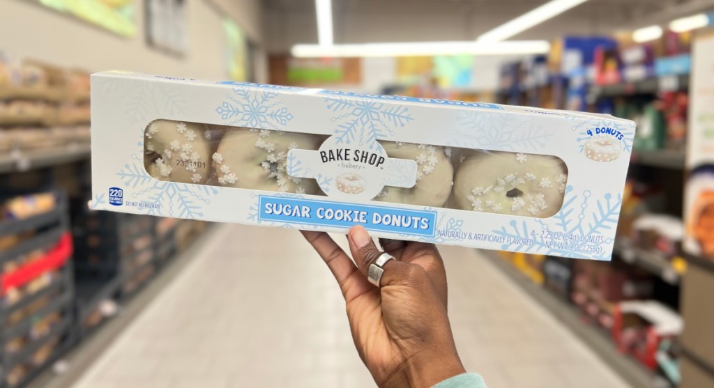 hand holding up a package of Aldi sugar cookie donuts