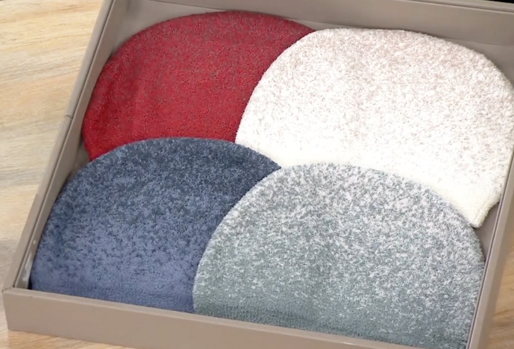 four beanies in a display box