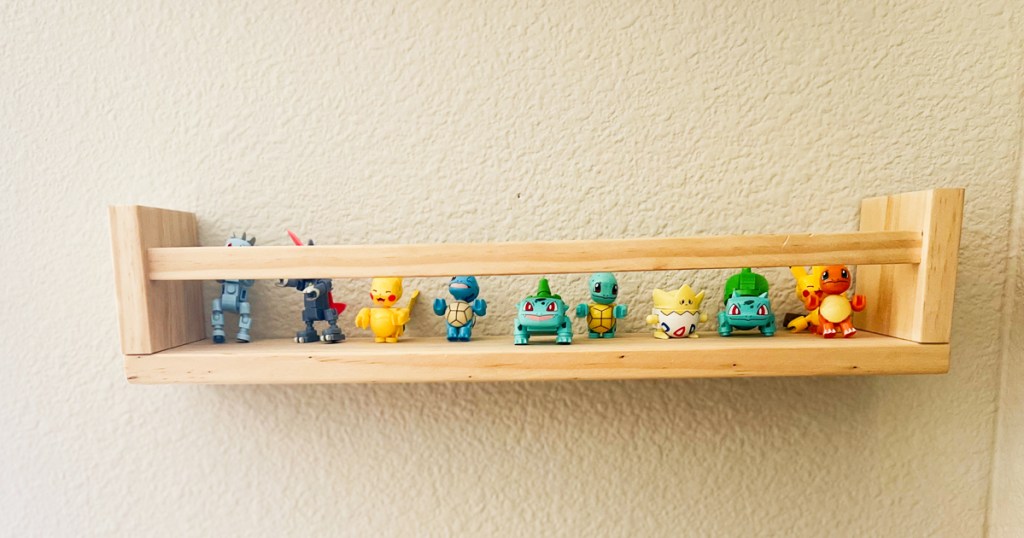 small pokemon figures on wooden shelf