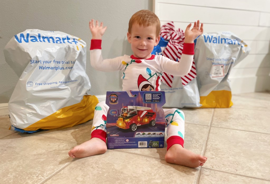 A young boy opening toys from Walmart