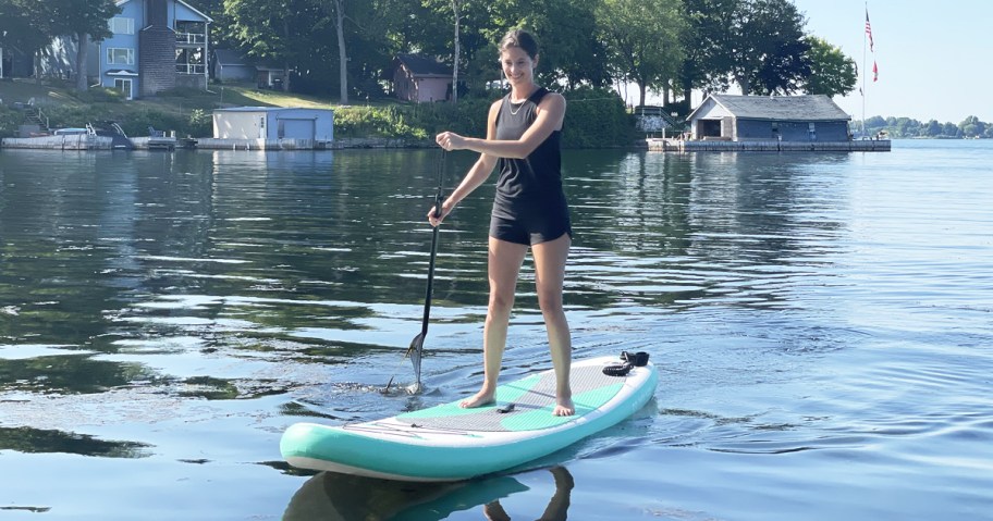 woman standing on inflatable paddle board