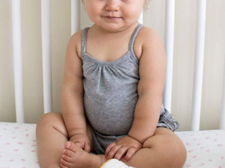 A baby in a Burt's Bees Classic Organic Cotton Baby Camisole Bodysuit