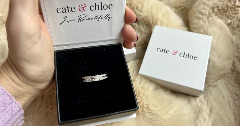 hand holding cate & chole earring box with silver hoop earrings