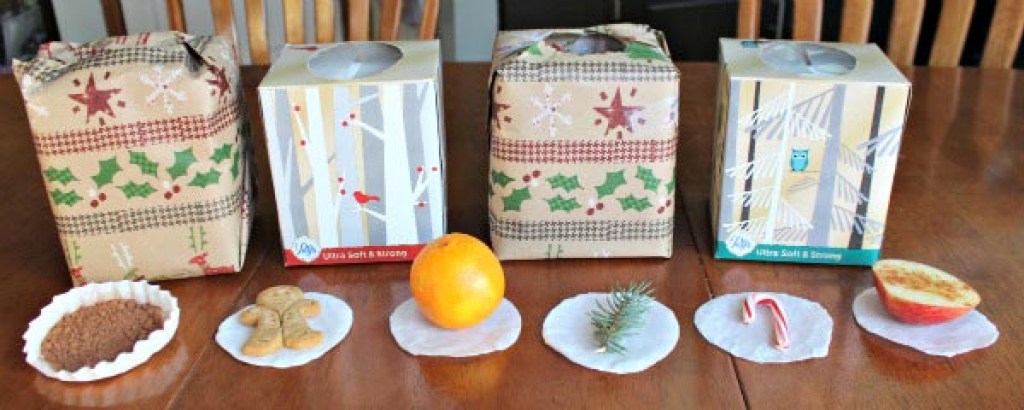 Christmas boxes with different holiday foods in front of them as part of a Christmas sensory challenge, one of the popular Christmas party games