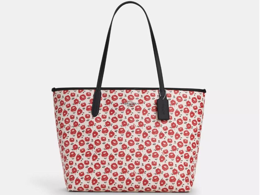 A tote with red flowers on it 
