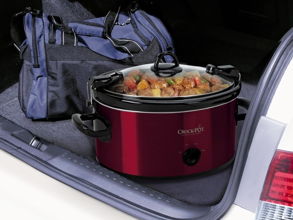 red crockpot in back of car trunk