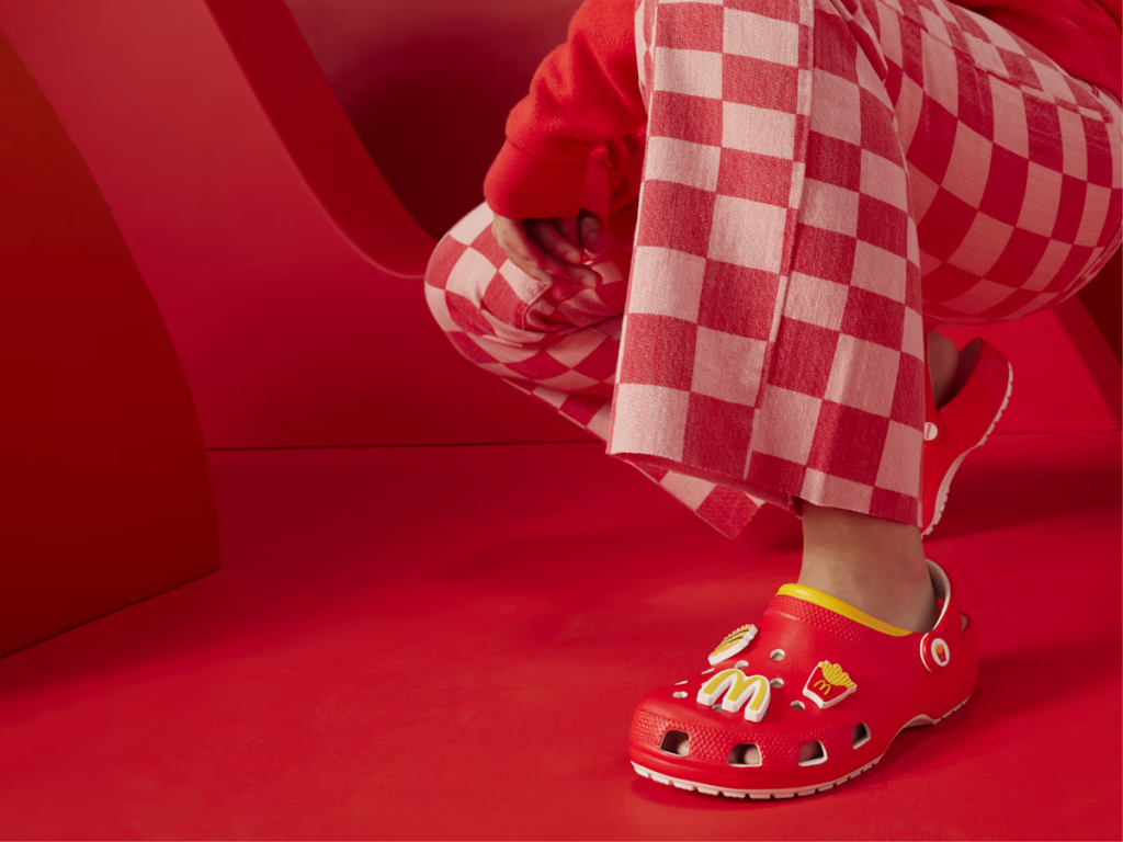 woman wearing red checkered pants and red McDonald's Crocs