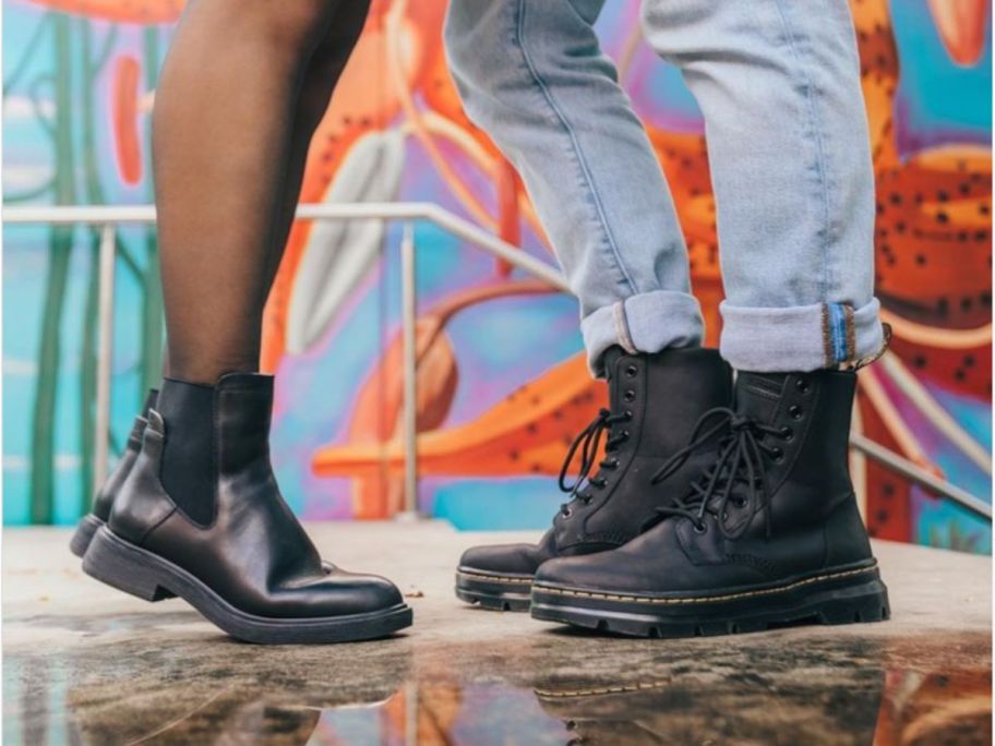 Two people wearing black boots