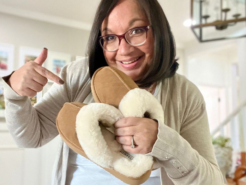 Woman pointing at a pair of Dearfoams slippers