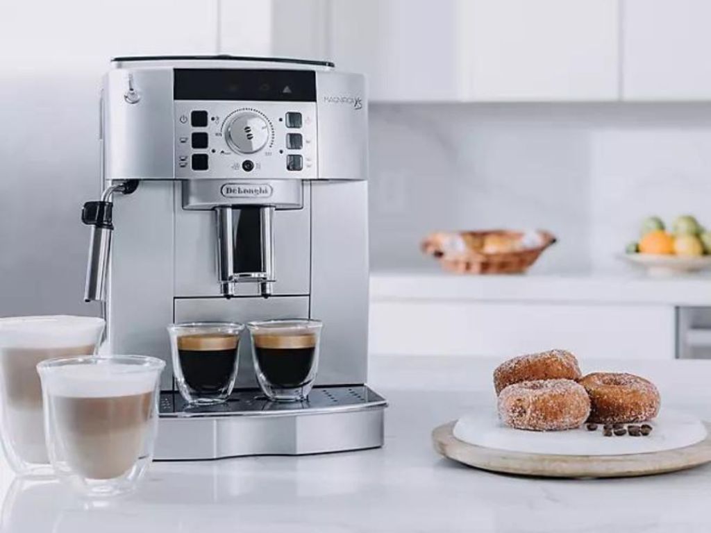 Delonghi Espresso Maker next to cappuccinos and a plate of pastries