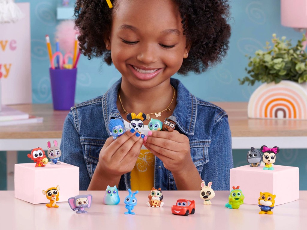 girl playing with Disney Doorables set