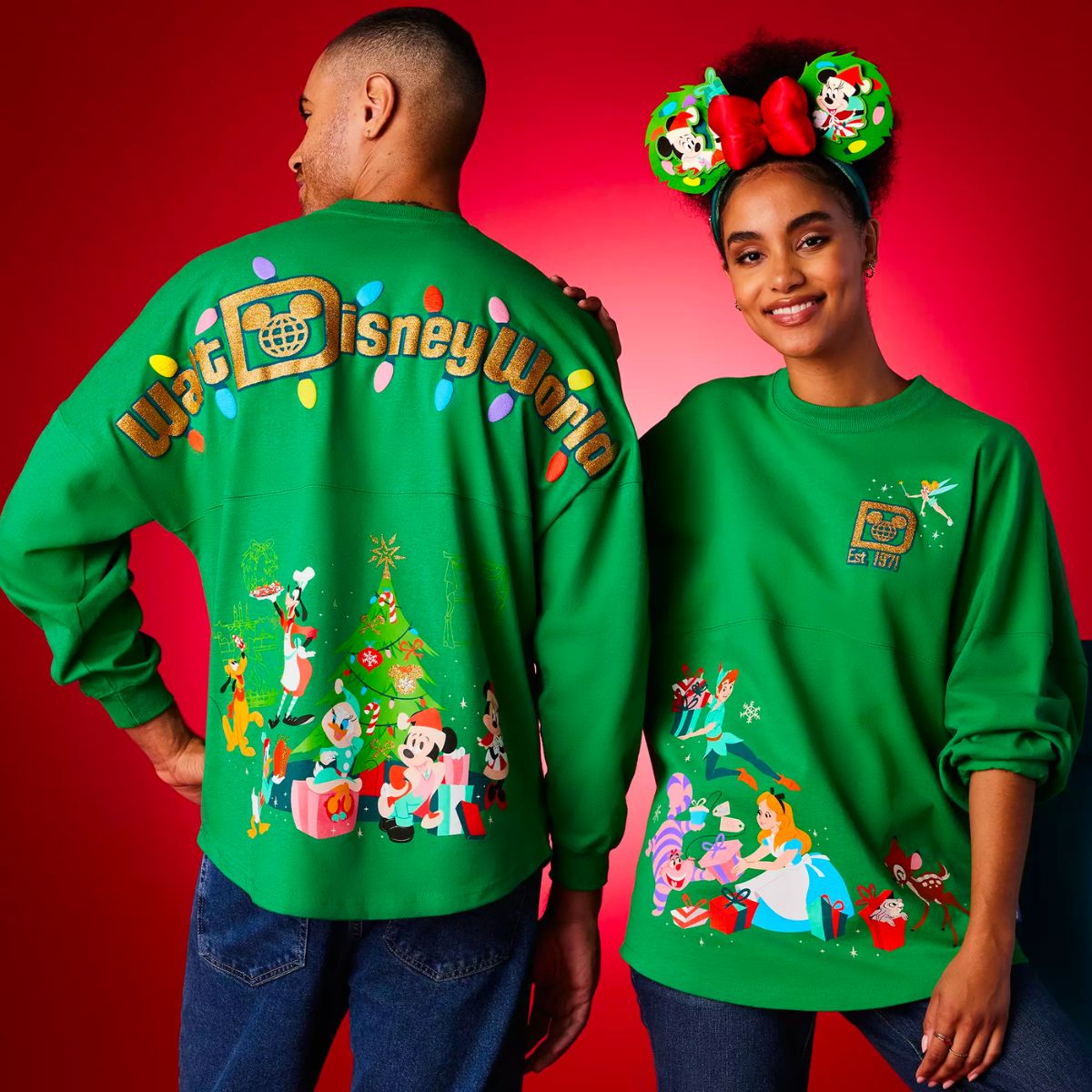 a male and female model wearing Disney holiday spirit jerseys in green