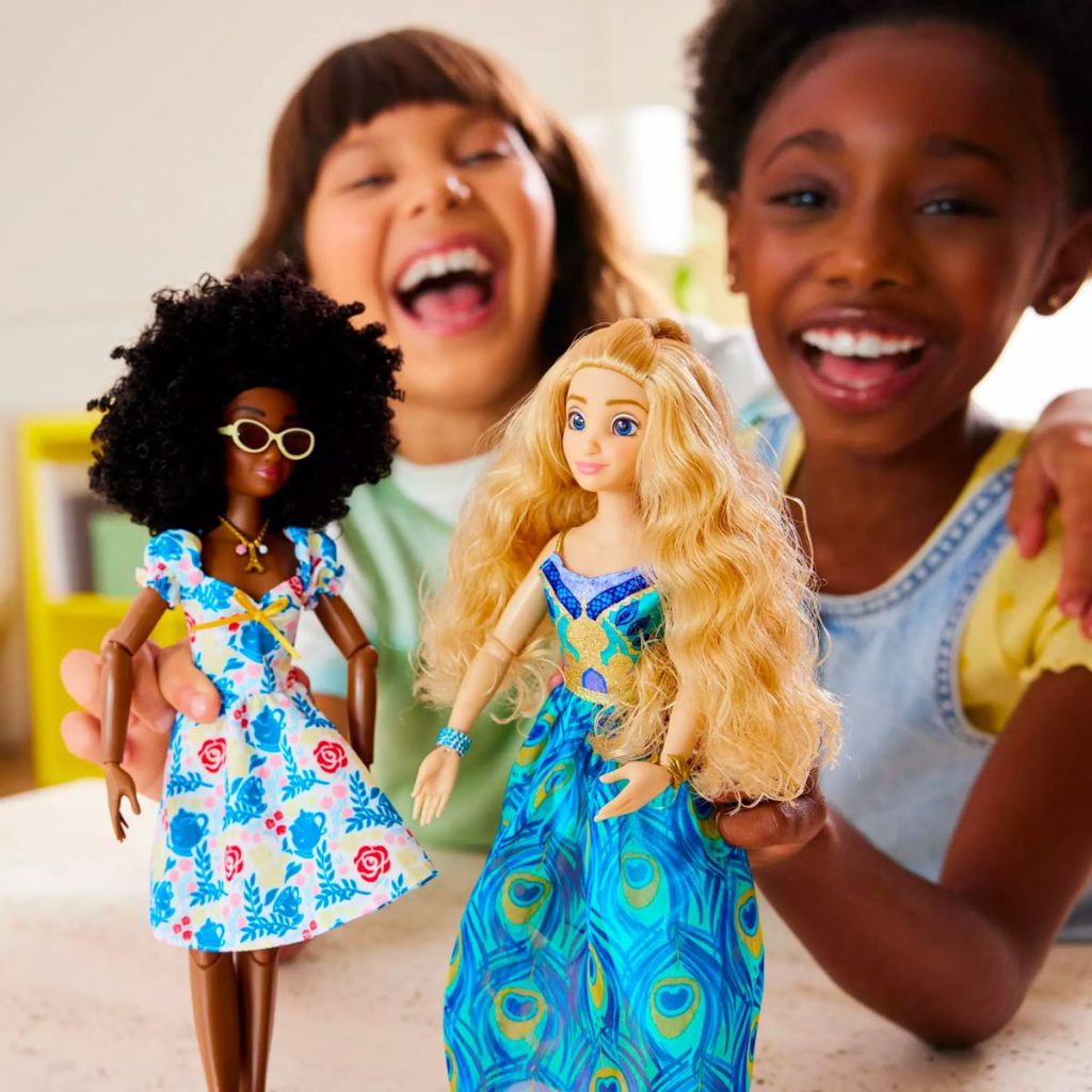 two little girls playing with dolls dressed in Disney ily 4EVER Doll Fashion Packs