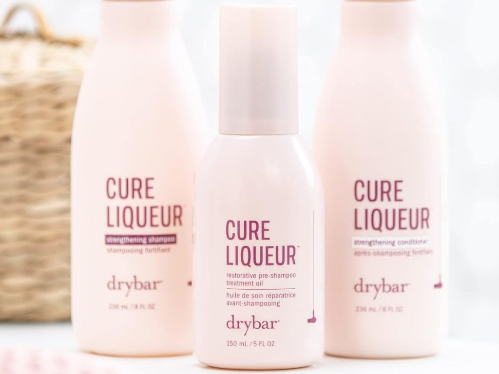 light pink bottle of Drybar Cure Liqueur Restorative Pre-Shampoo Treatment Oil