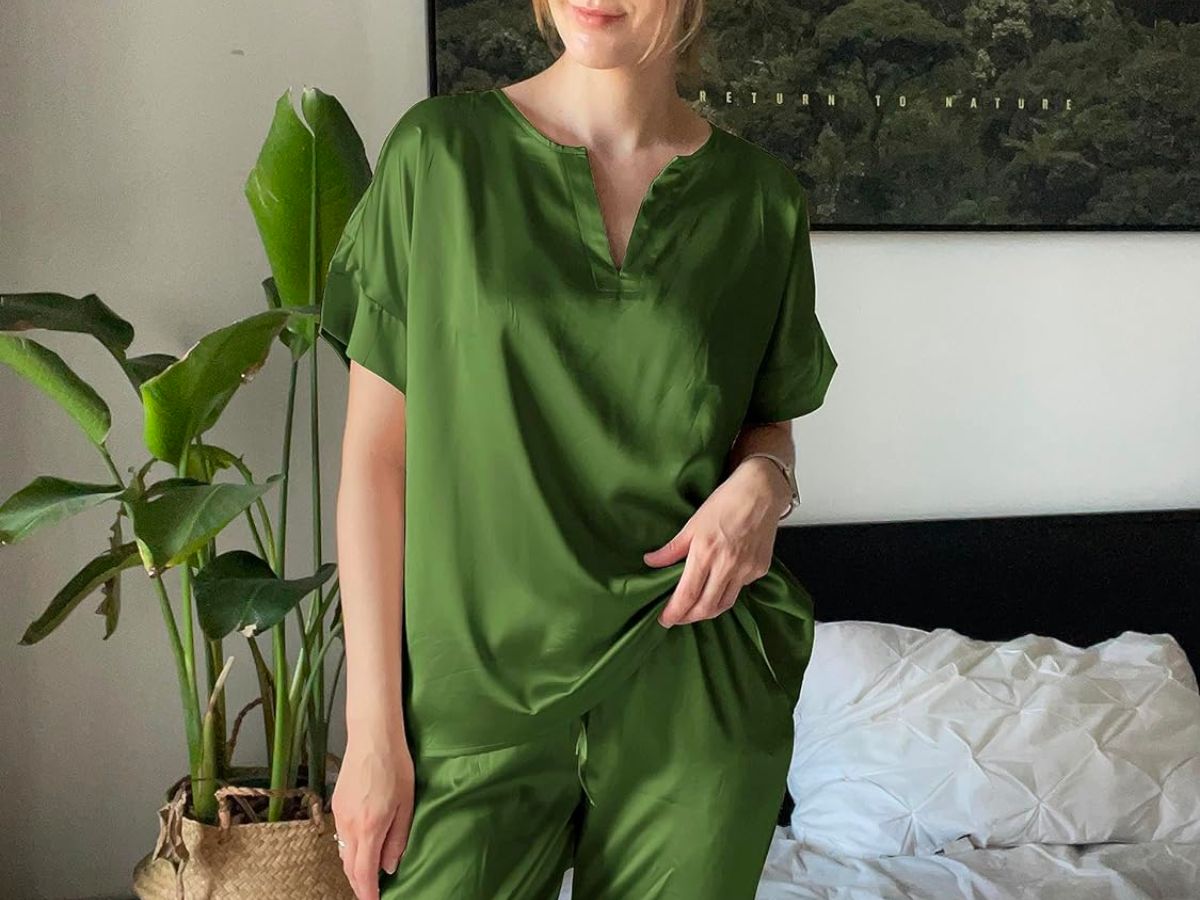 a woman standing in a bedroom wearing an Ekouaer 2-Piece Satin Pajama Lounge Set in army green