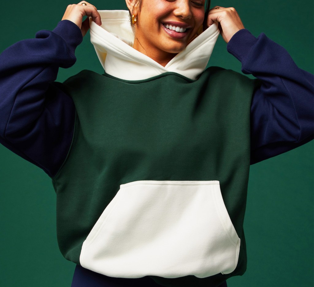 woman in a blue, green, and white colorblock hoodie