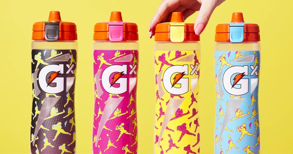 line of 4 gatorade bottles with hand grabbing one of them