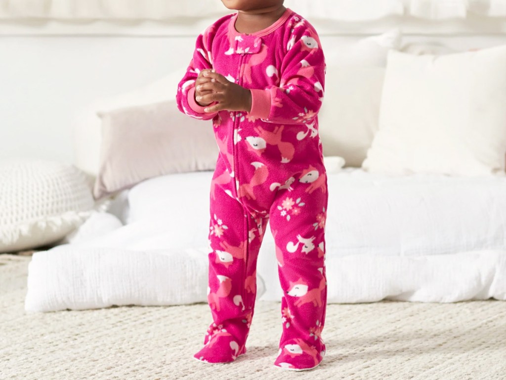girl wearing pink fox print fleece pajamas