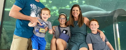 family posing for photo at aquarium