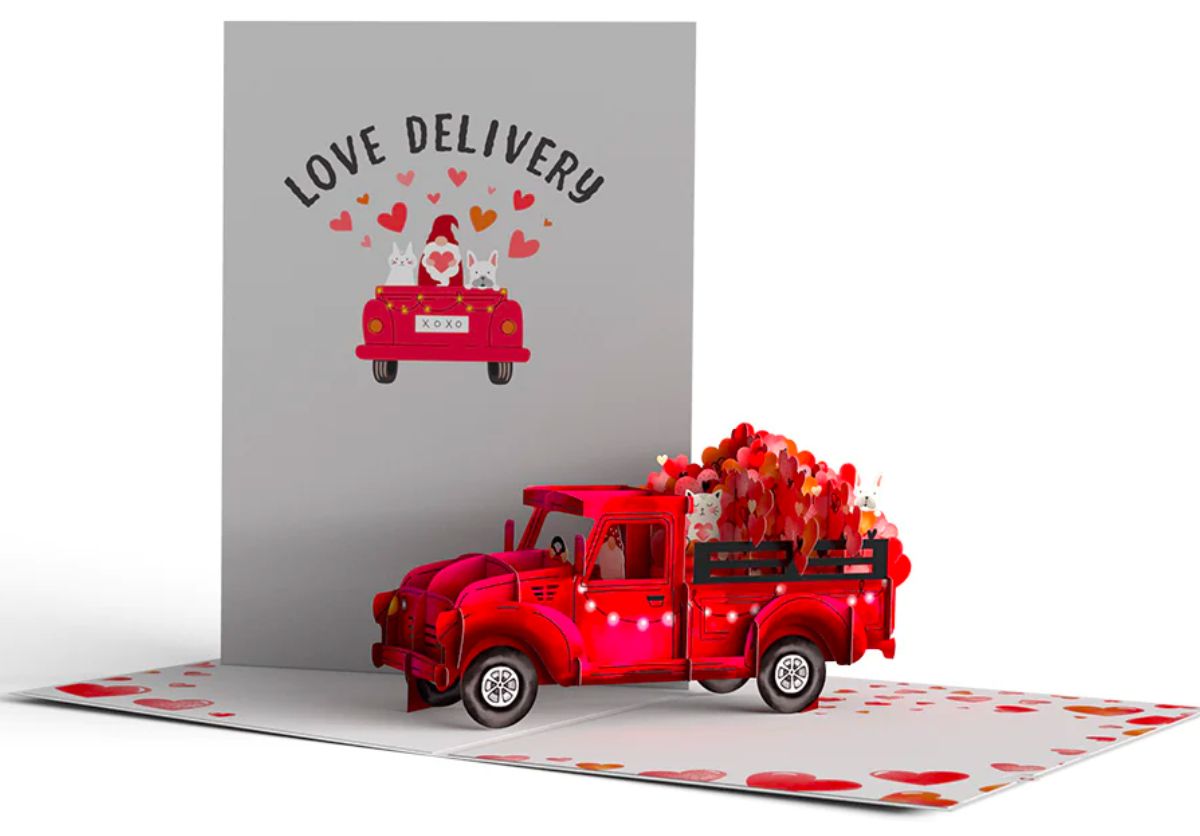 Giant Love Delivery Truck Valentine's Pop Up Card open on a tabletop stock image