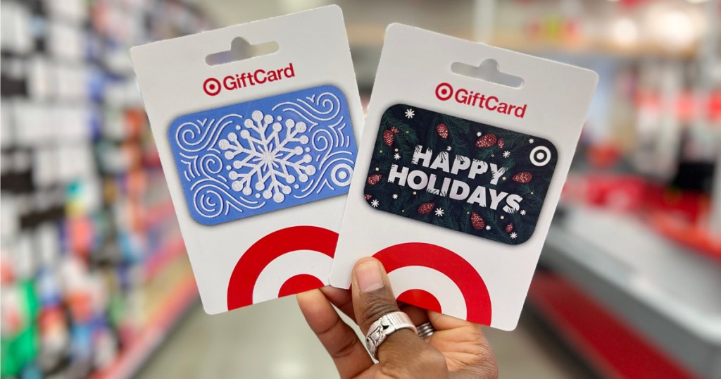 Gift Cards at Target being held by a person in the aisle