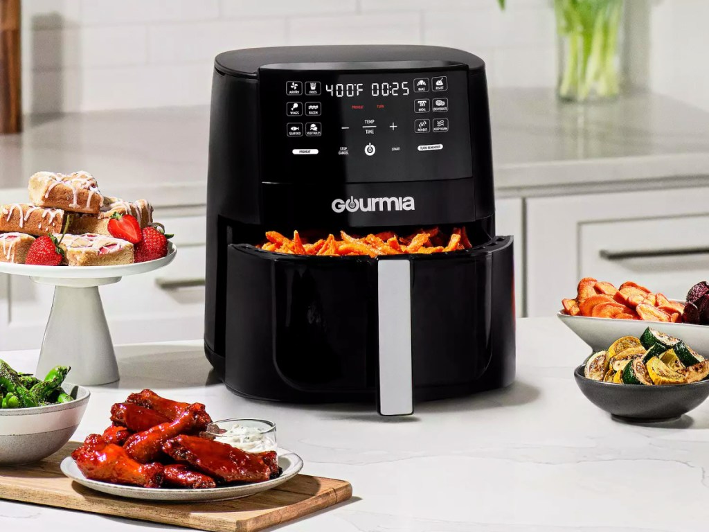 Gourmia Air Fryer surrounded by food on a counter