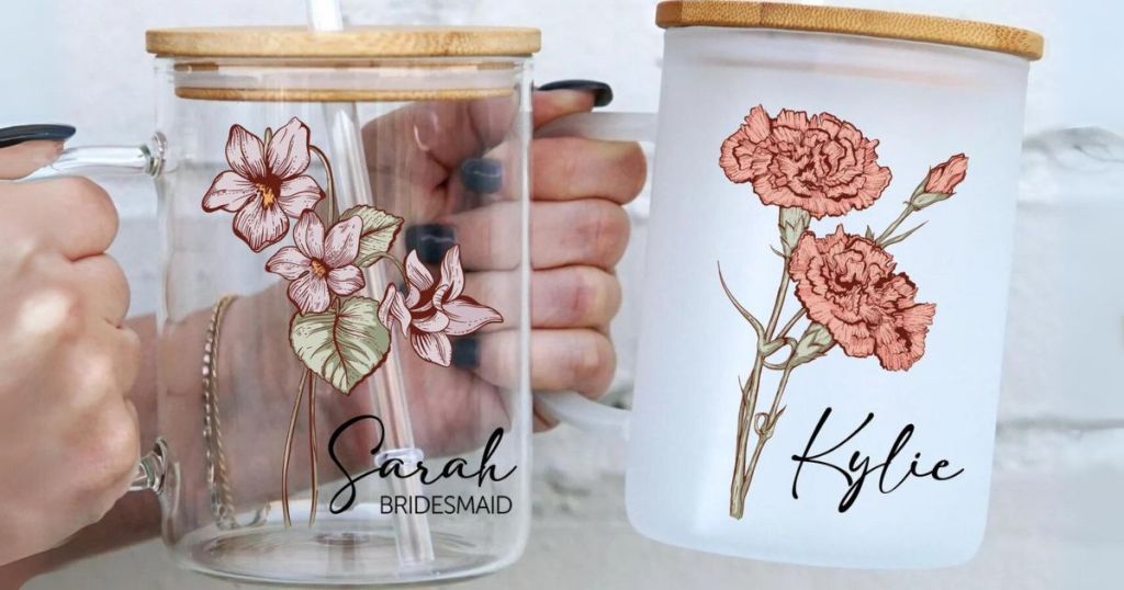 hands holding clear personalized birth flower name mugs